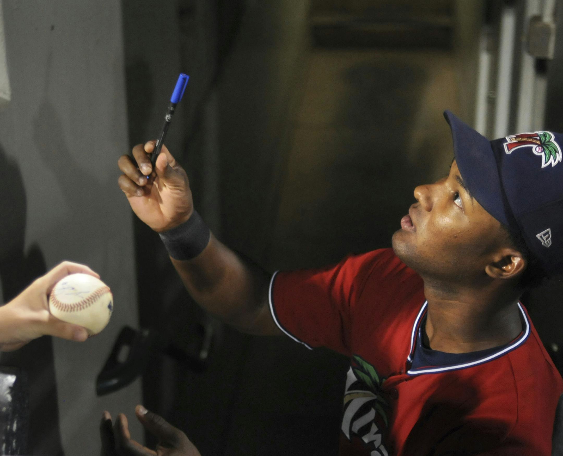 (06/14/12 Fort Myers) Daniel Santana (cq) signs autographs from the dugout after the Bradenton Marauders vs. Fort Myers Miracle June 14, 2012 at Hammond Stadium in Fort Myers, FL. Miracle lost the game 0-6 with only four hits overall. Photo by Leah Millis/Special to Star Tribune ORG XMIT: MIN2013083017414354