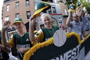 Maddy Freking, center, and other members of the Coon Rapids Little League team were part of a parade before the 2019 tournament.