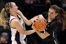 UConn’s Paige Bueckers, left, the National Player of the Year as a freshman last season, returned to the Huskies’ lineup Friday after missing 19 g