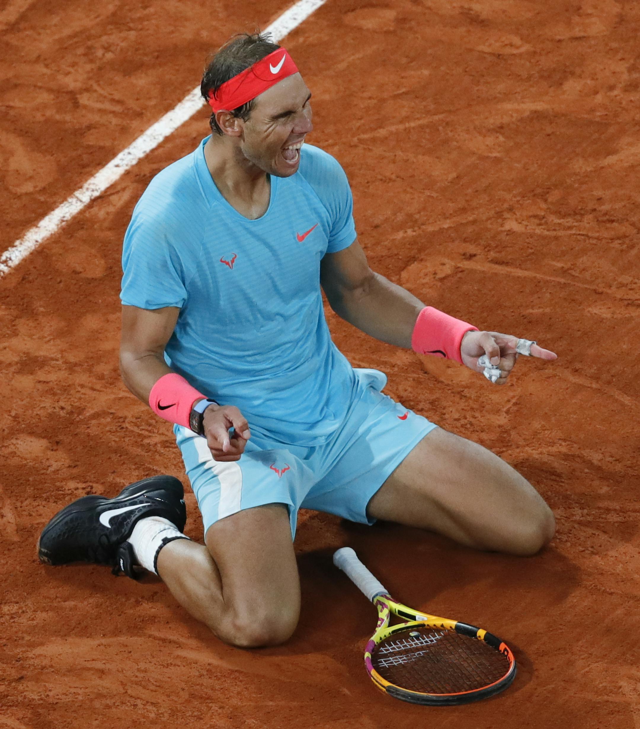 Spain's Rafael Nadal celebrates winning the final match of the French Open tennis tournament against Serbia's Novak Djokovic in three sets, 6-0, 6-2, 7-5, at the Roland Garros stadium in Paris, France, Sunday, Oct. 11, 2020. (AP Photo/Christophe Ena)