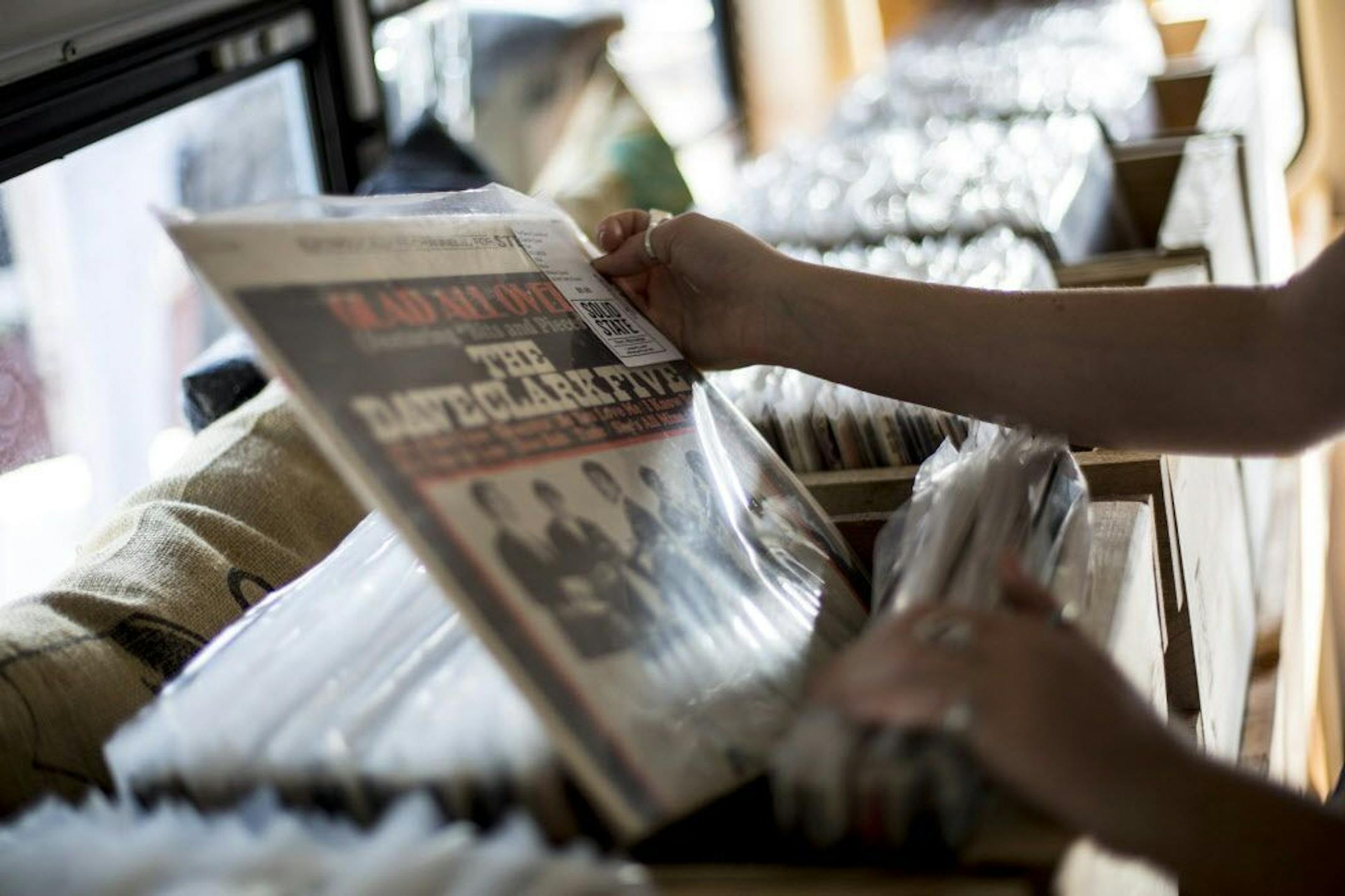 Alison Caldwell pulls out a Dave Clark Five record as she checks out the inventory.