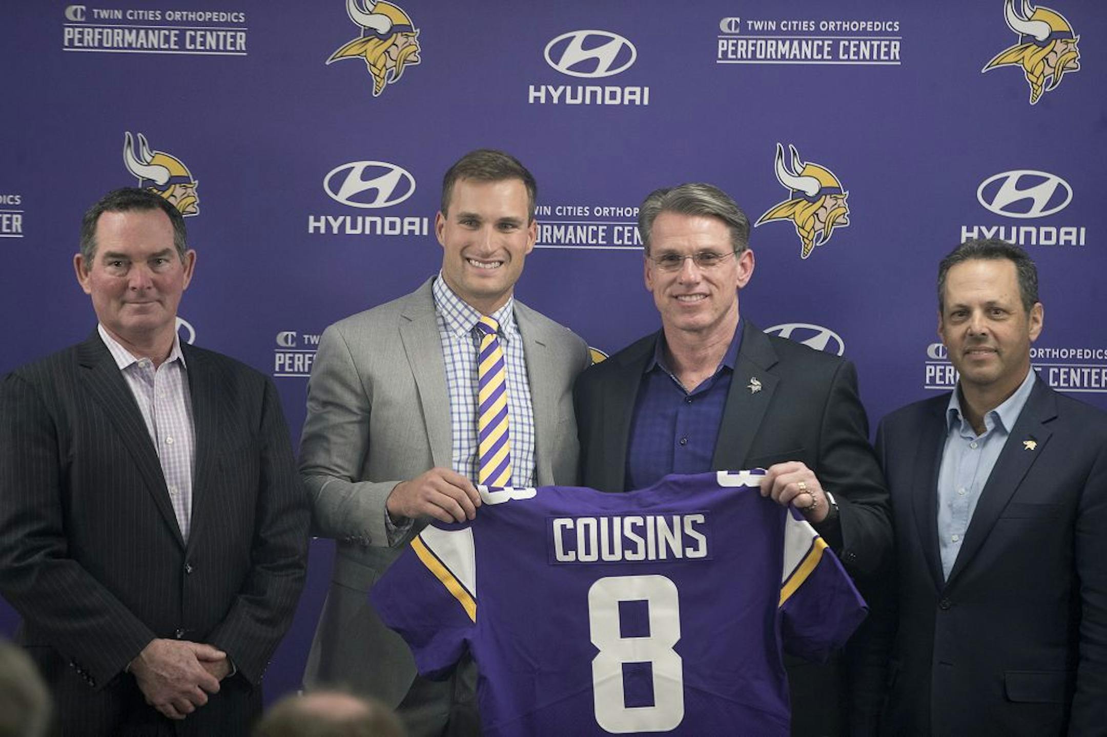 Minnesota Vikings Head Coach Mike Zimmer, left, stood next to Kirk Cousins, along with general manager Rick Spielman and co-owner Mark Wilf as he officially became a Vikings quarterback Thursday.
