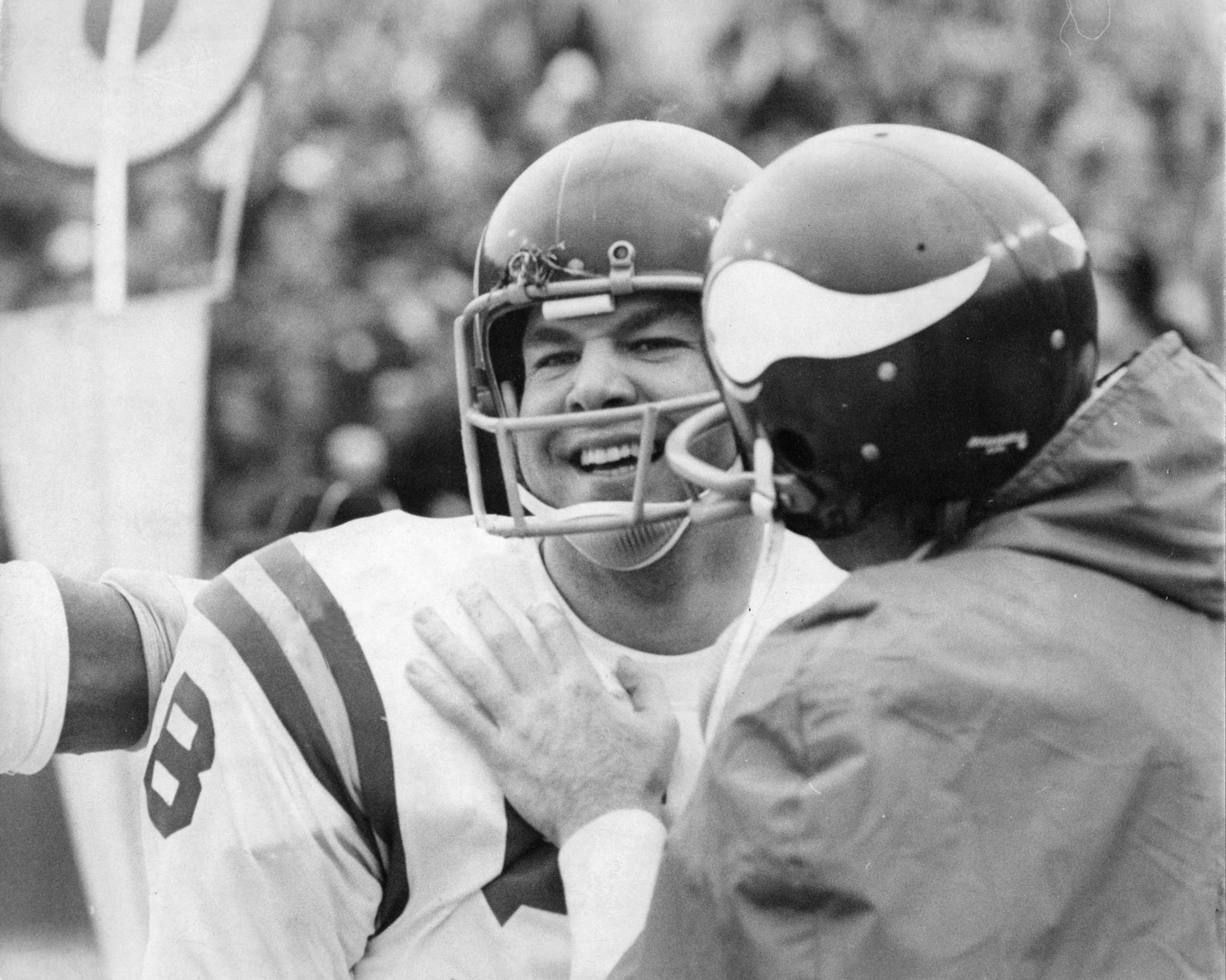 Minnesota Vikings linebacker Wally Hilgenberg was congratulated by a teammate after he intercepted a Green Bay pass and ran 14 yards to score the clinching touchdown as the Vikings defeated the Packers 27-13 Sunday. October, 1972