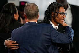 Rob Dillingham, right, reacts after being selected by San Antonio during the first round of the NBA draft Wednesday. Moments later, the Spurs traded t
