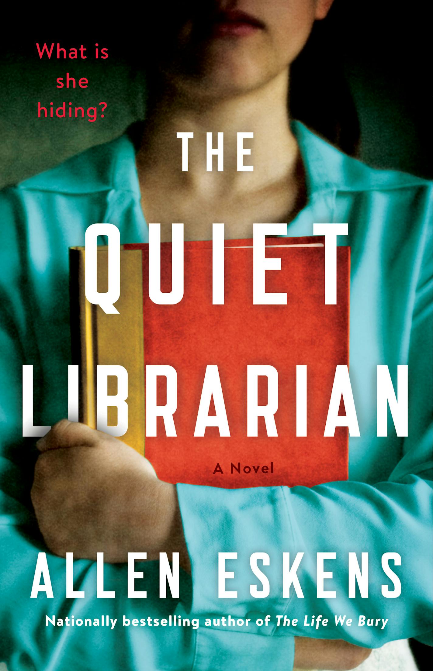 cover of The Quiet Librarian is a photo of the torso of a woman who is holding a book