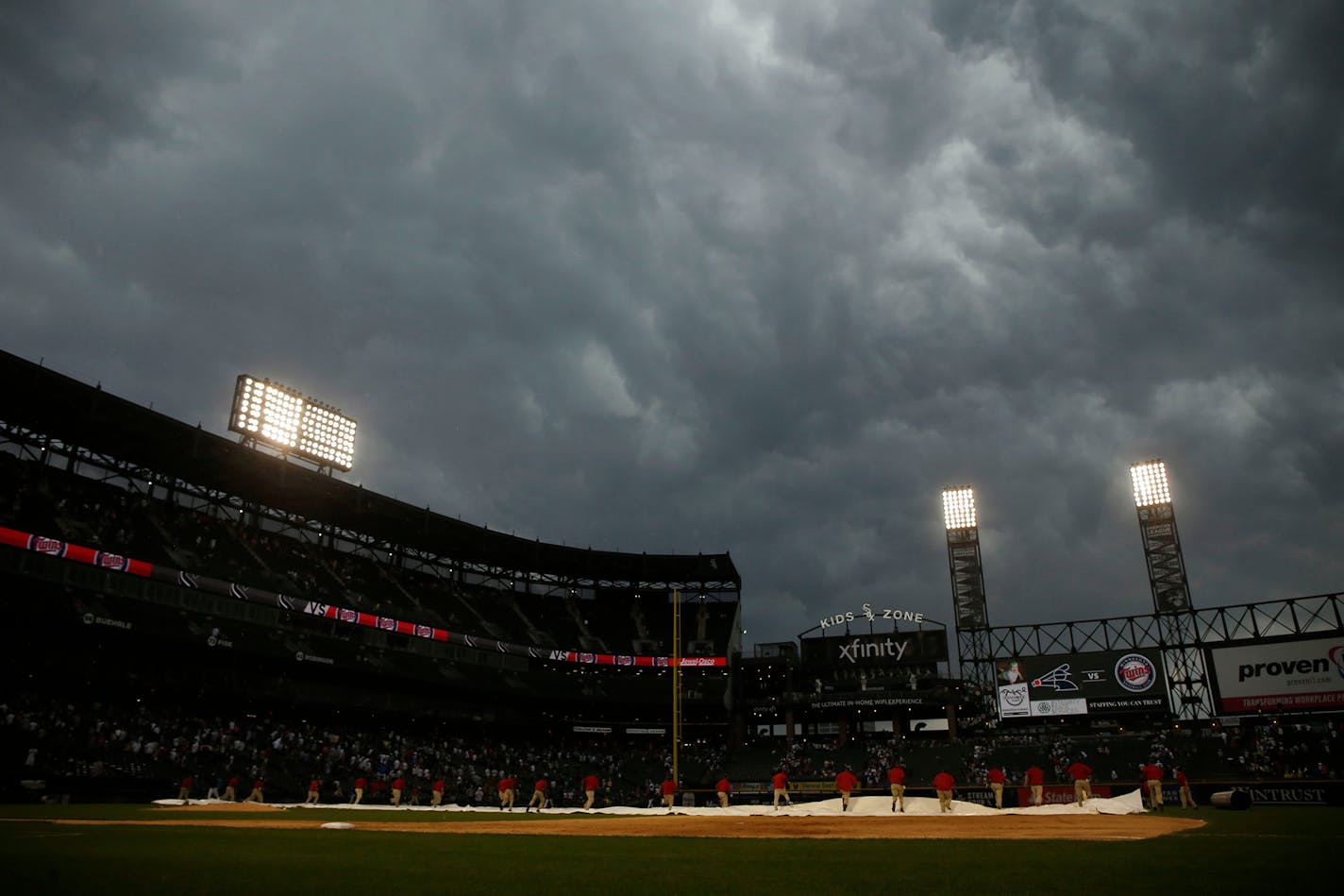 The Guaranteed Rate Field grounds crew pulled the tarp across the field during a rain delay after five innings of the Twins-White Sox game Sunday. Chicago led 2-0 at the time, behind ace Lucas Giolito, and held on after resuming play to win 4-3.