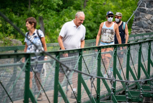 (From left) Patsy and Warren Thieve from Bloomington crossed the swinging bridge while being followed by their son-in-law David Turley and his husband