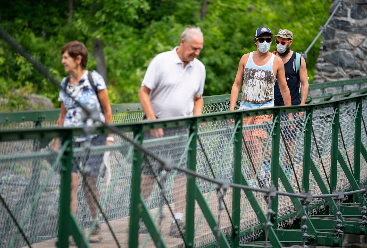 (From left) Patsy and Warren Thieve from Bloomington crossed the swinging bridge while being followed by their son-in-law David Turley and his husband Peter Thieve who were visiting from New York