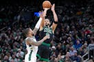 Celtics forward Jayson Tatum shoots against Bucks guard Damian Lillard on March 20. While the Celtics have maintained the best record in the league fo