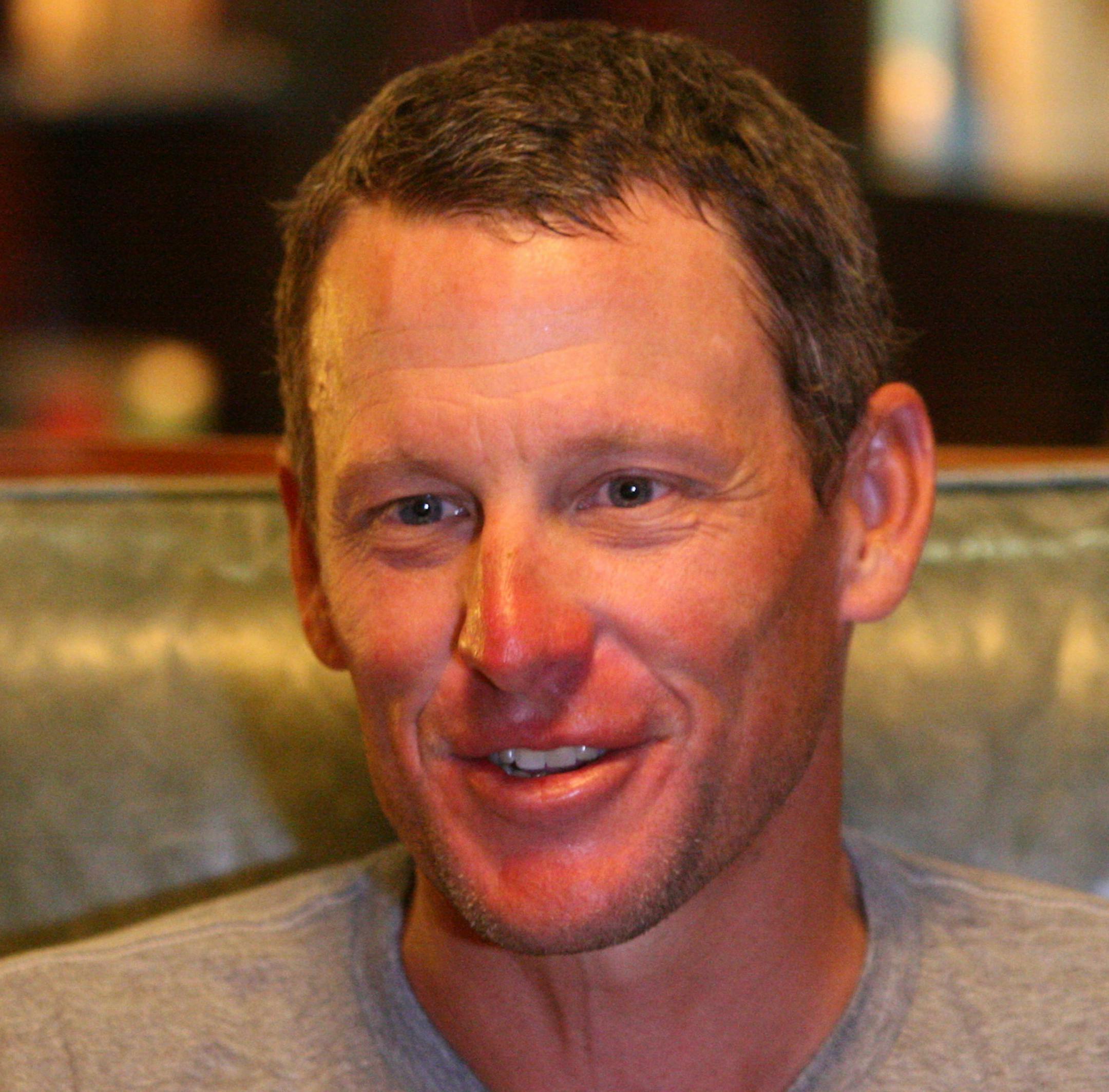 In this Monday, July 22, 2013 photo, Lance Armstrong talks to a reporter after finishing the first leg of the Register's Annual Great Bicycle Ride Across Iowa, or RAGBRAI, in Des Moines, Ia. RAGBRAI is a weeklong bicycle ride through the state sponsored by the Des Moines Register. (AP Photo/The Des Moines Register, Andrea Melendez)) NO SALES ONLINE OUT, TV OUT, MAGS OUT, NO SALES, MANDATORY CREDIT ORG XMIT: MIN2013082514110115