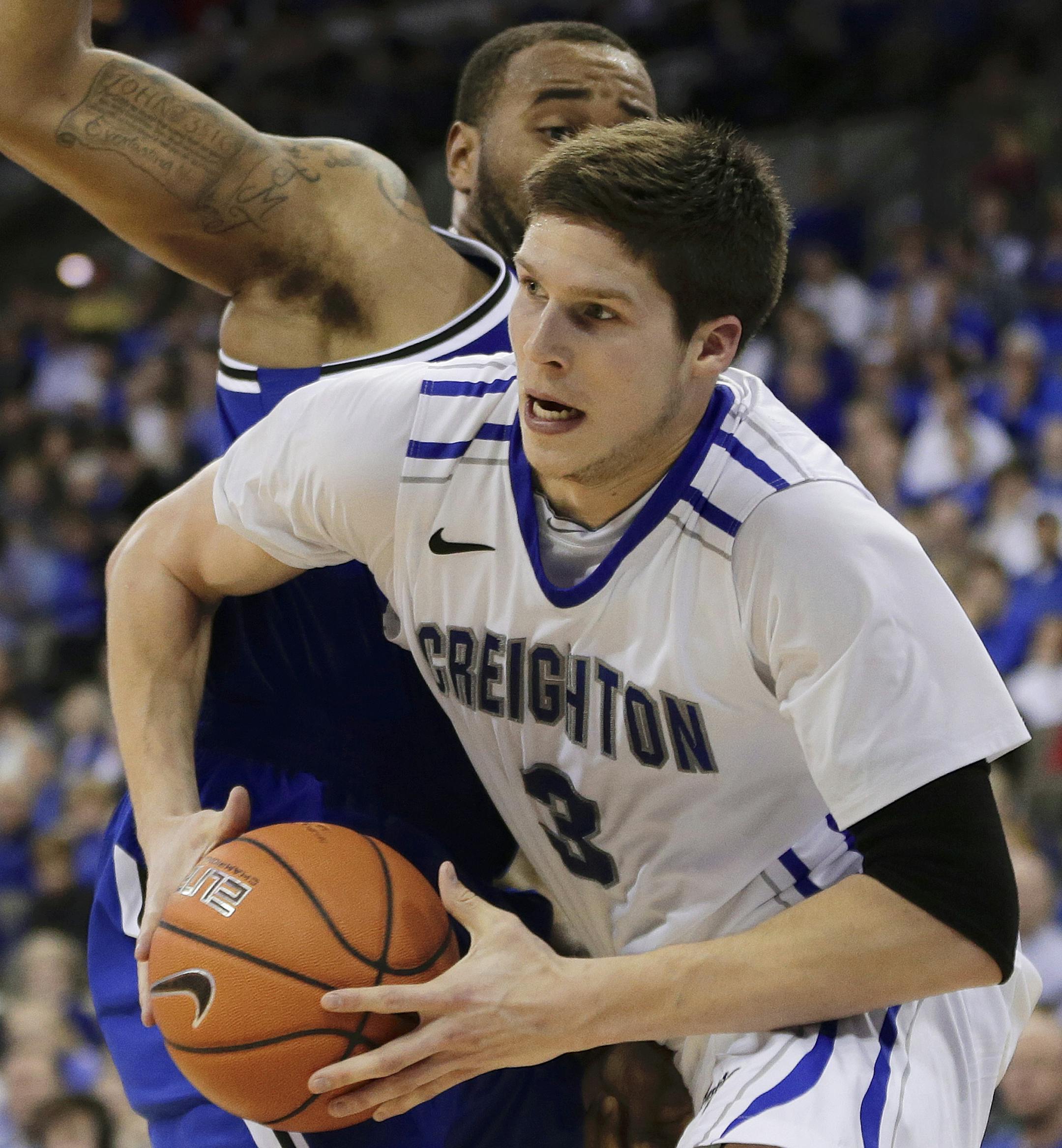 Creighton's Doug McDermott, right, drives past Seton Hall's Eugene Teague, left, in the second half of an NCAA college basketball game in Omaha, Neb., Sunday, Feb. 23, 2014. Creighton won 72-71. (AP Photo/Nati Harnik)