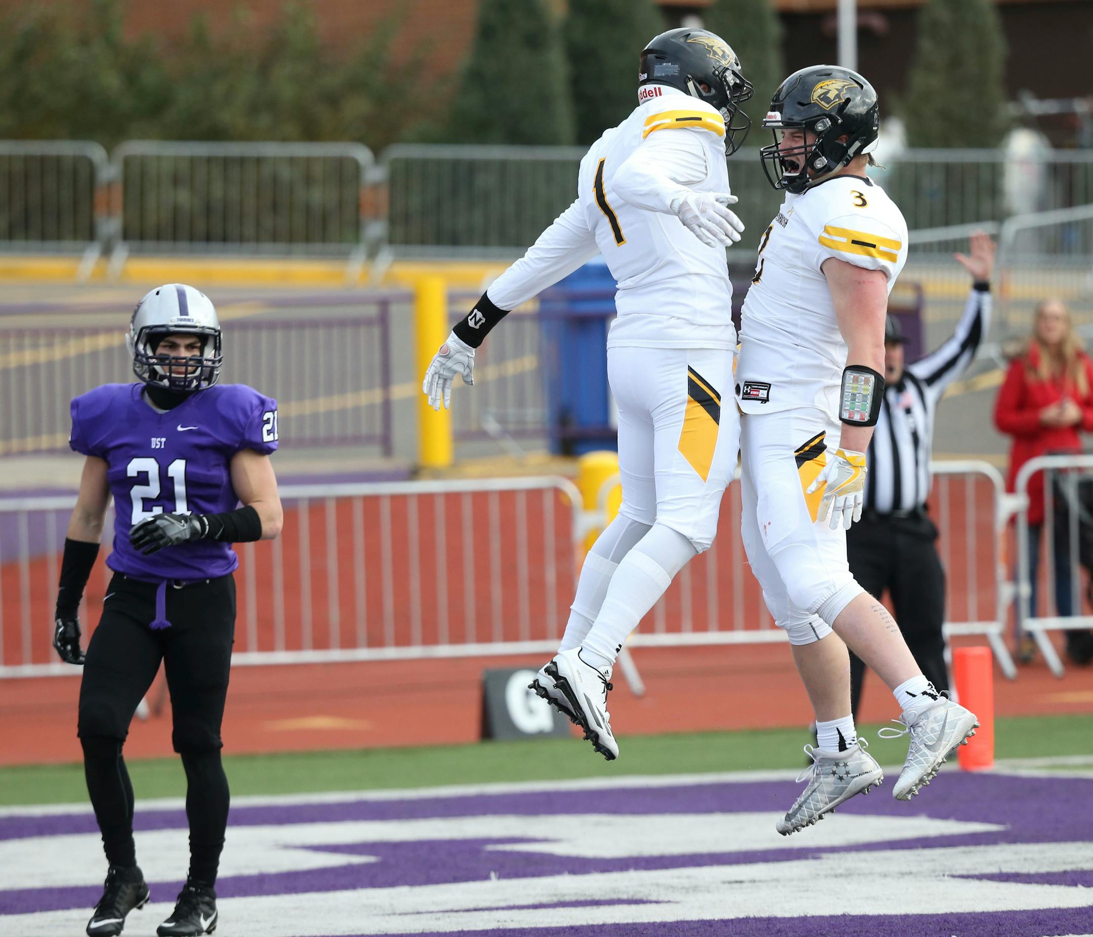 St. Thomas defensive back Bennett Celichowski (21) watches as Wisconsin-Oshkosh receiver Sam Mentkowski (1) celebrates a touchdown reception with teammate Cody Moon (3) during an NCAA division III college football playoff game, Saturday, Dec. 3, 2016, at O'Shaughnessy Stadium in St. Paul, Minn. (David Joles/Star Tribune via AP)