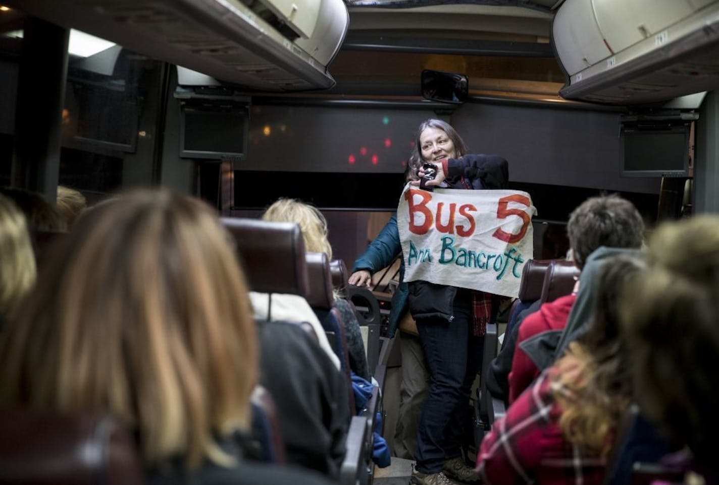 Deborah Capouch held up the bus sign that included it's name, Anne Bancroft, before it hit the road for the Woman's March on Washington early Friday morning, January 20, 2016, in Minneapolis, Minn. The eight buses chartered from Minnesota were all named after prominent Minnesota women.