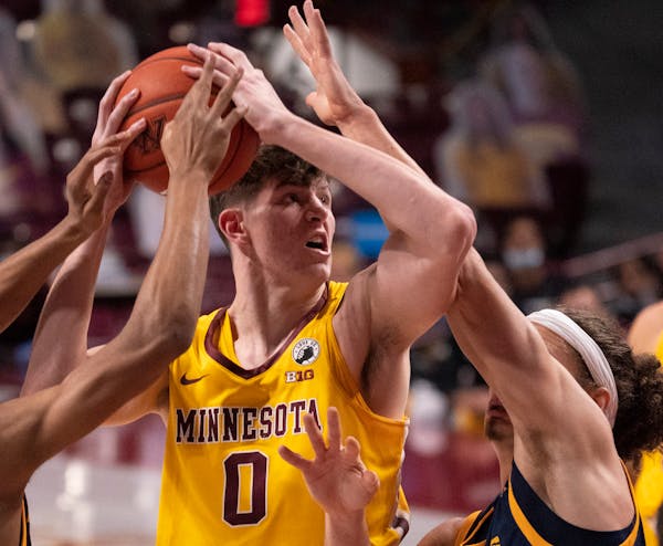 Gophers center Liam Robbins tried to get a first-half shot off in heavy traffic. He had 14 points at halftime and finished with 27.