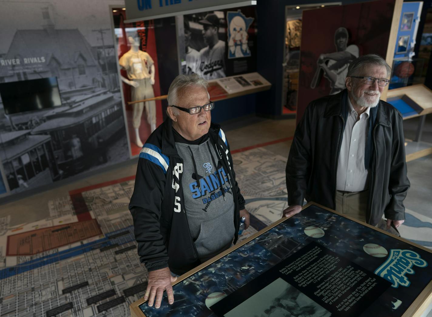 Saints ushers Tom Mattson left, and John Wenzel looked over an interactive display at the the City of Baseball Museum at CHS Field