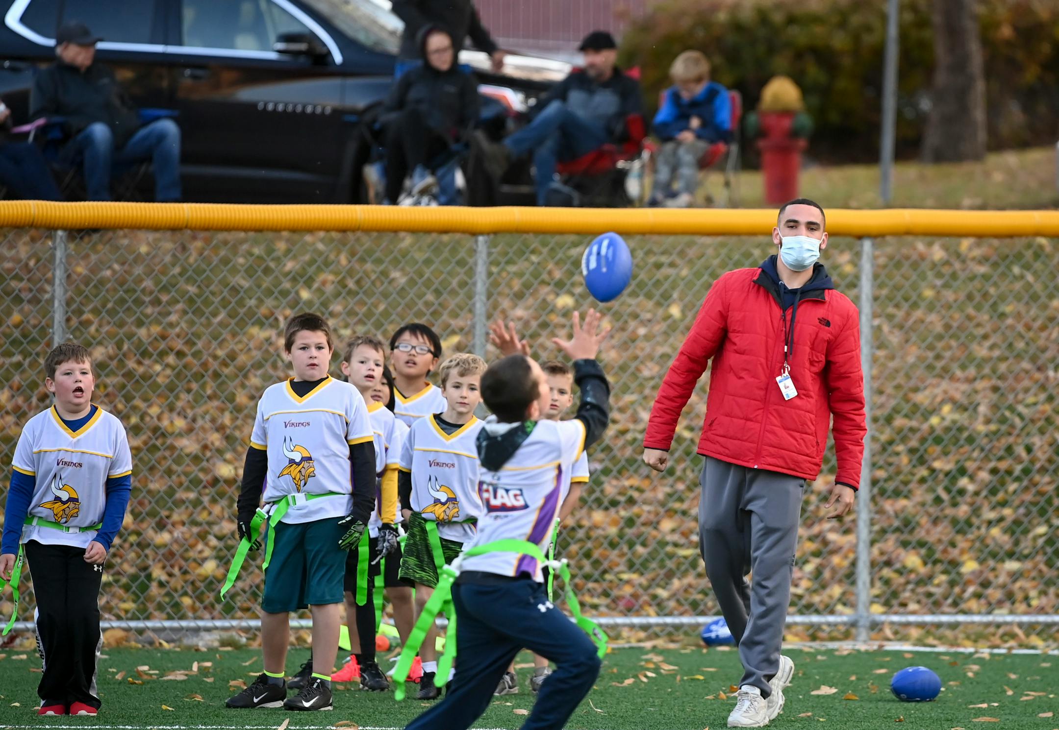 Tyler Randall, an 8U assistant flag football coach, threw the ball to a kid during practice Wednesday. He said coaching has been difficult during the pandemic, but he�s getting used to it. �They�re having fun though,� he said of the kids. �That�s the most important part.�