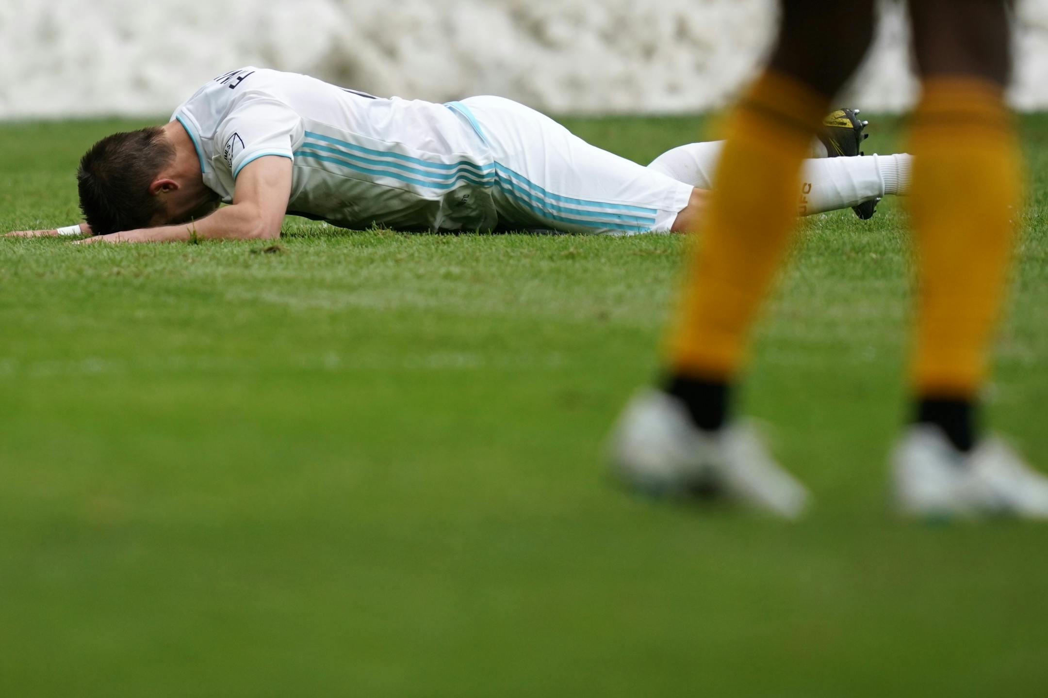 Minnesota United midfielder Ethan Finlay (13) laid on the grass after he collided with New York City midfielder James Sands (16) while trying to take a shot on New York City goalkeeper Sean Johnson (1) in the second half.