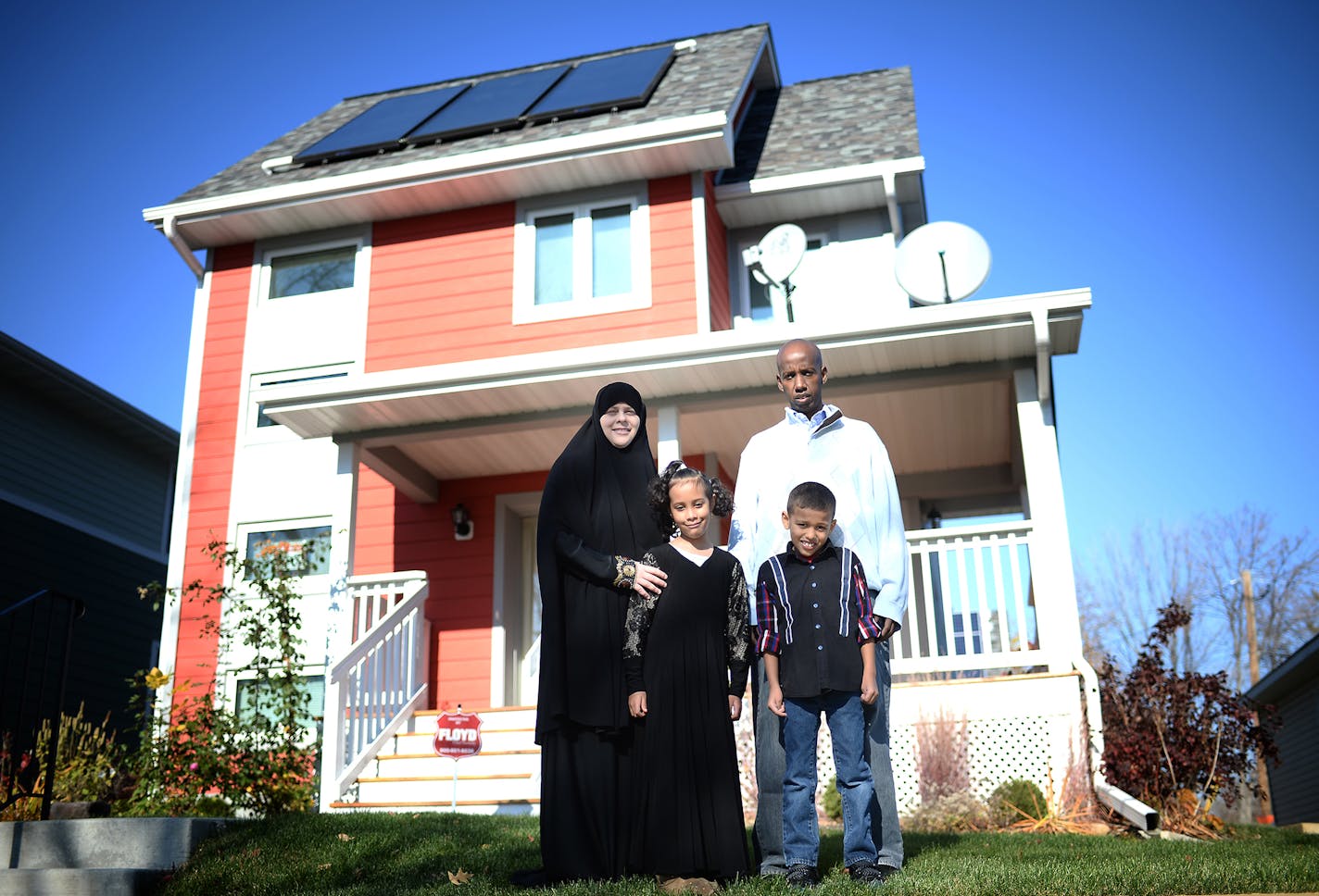 Sarah Olson, Mohamed Abdi and their two 7-year old children, Jamal and Sofia, were photographed in front of their Habitat for Humanity home of two years in North Minneapolis Saturday. ] (AARON LAVINSKY/STAR TRIBUNE) aaron.lavinsky@startribune.com A newly released study by the Wilder Foundation of families that have moved into Habitat for Humanity homes reads like a litany of good news. Habitat families report a host of positive impacts from their move. More than half say their kids are doing bet