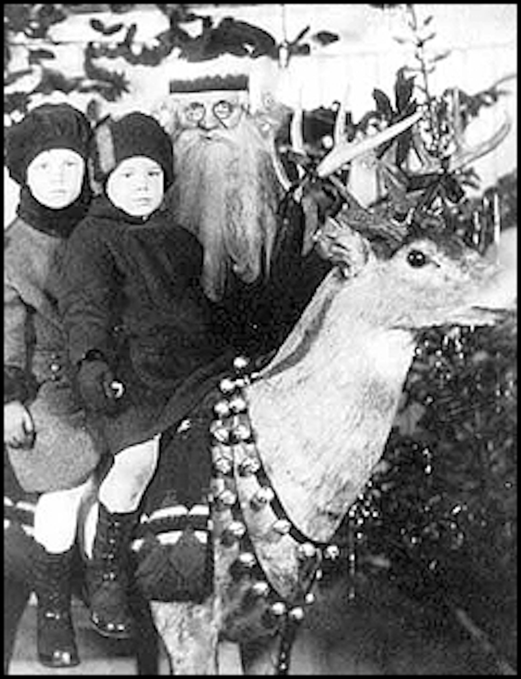 Duluth, 1925: Muriel and Lorraine Gill climbed atop a reindeer for their moment with Santa.