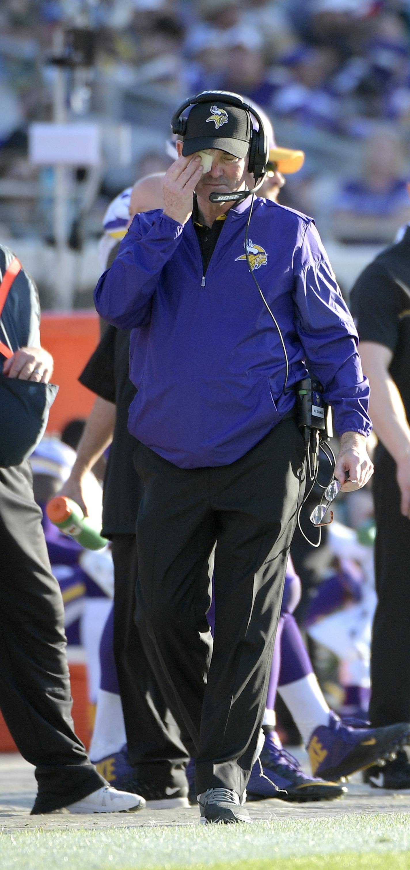 Minnesota Vikings head coach Mike Zimmer rubs the patch on his eye on the sideline during the second half of an NFL football game against the Jacksonville Jaguars in Jacksonville, Fla., Sunday, Dec. 11, 2016. The Vikings won 25-16. (AP Photo/Phelan M. Ebenhack)