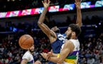 Minnesota Timberwolves forward Andrew Wiggins (22) is fouled by New Orleans Pelicans guard Kenrich Williams (34) during the first half of an NBA baske