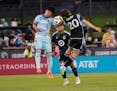 Colorado's Omir Fernández, left, challenges Minnesota United's Wil Trapp for a ball during the first half Saturday, with midfielder Carlos Harvey loo