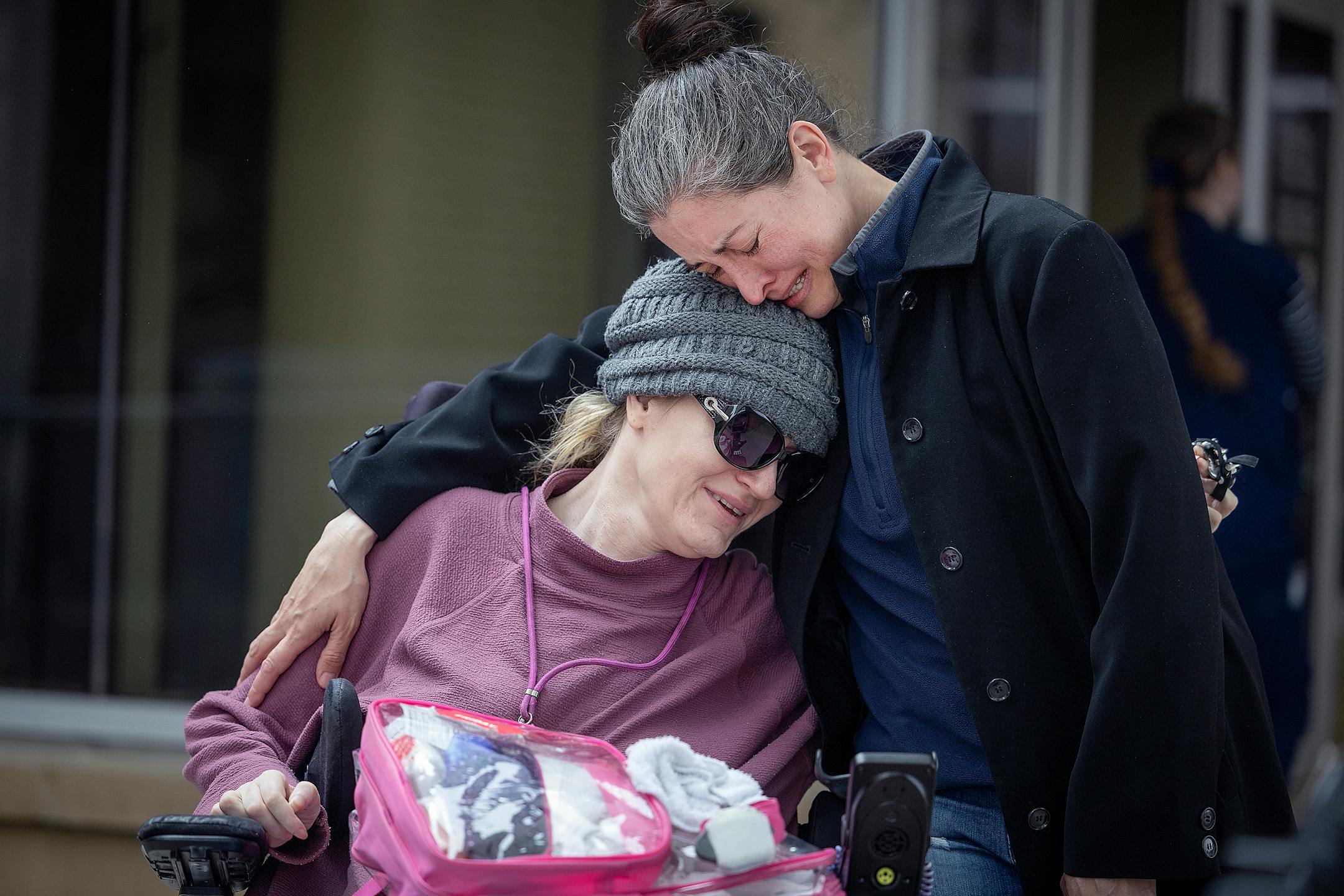 Attorney Misti Okerlund cries as her client, Cindy Hagen smells and feels the air after 293 days of being confined to a hospital room at the Mayo Clinic hospital in Austin, Minn., on Friday, April 28, 2023. "What is that, what is that," questioned Hagen of the air.