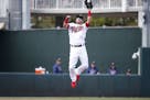 Minnesota Twins third baseman Josh Donaldson leaps to catch a line drive during a spring training baseball game against the Tampa Bay Rays, Friday, Ma