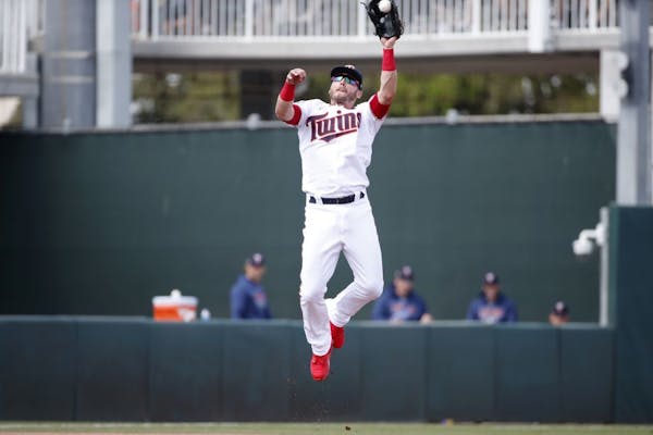 Minnesota Twins third baseman Josh Donaldson leaps to catch a line drive during a spring training baseball game against the Tampa Bay Rays, Friday, Ma