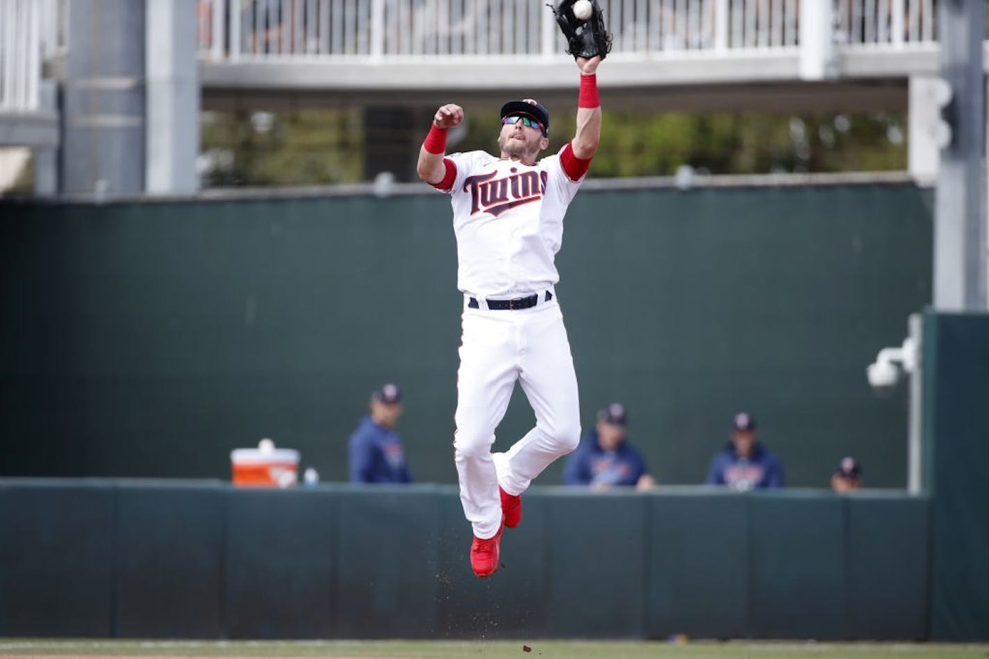 Minnesota Twins third baseman Josh Donaldson leaps to catch a line drive during a spring training baseball game against the Tampa Bay Rays, Friday, March 6, 2020, in Fort Myers, Fla.