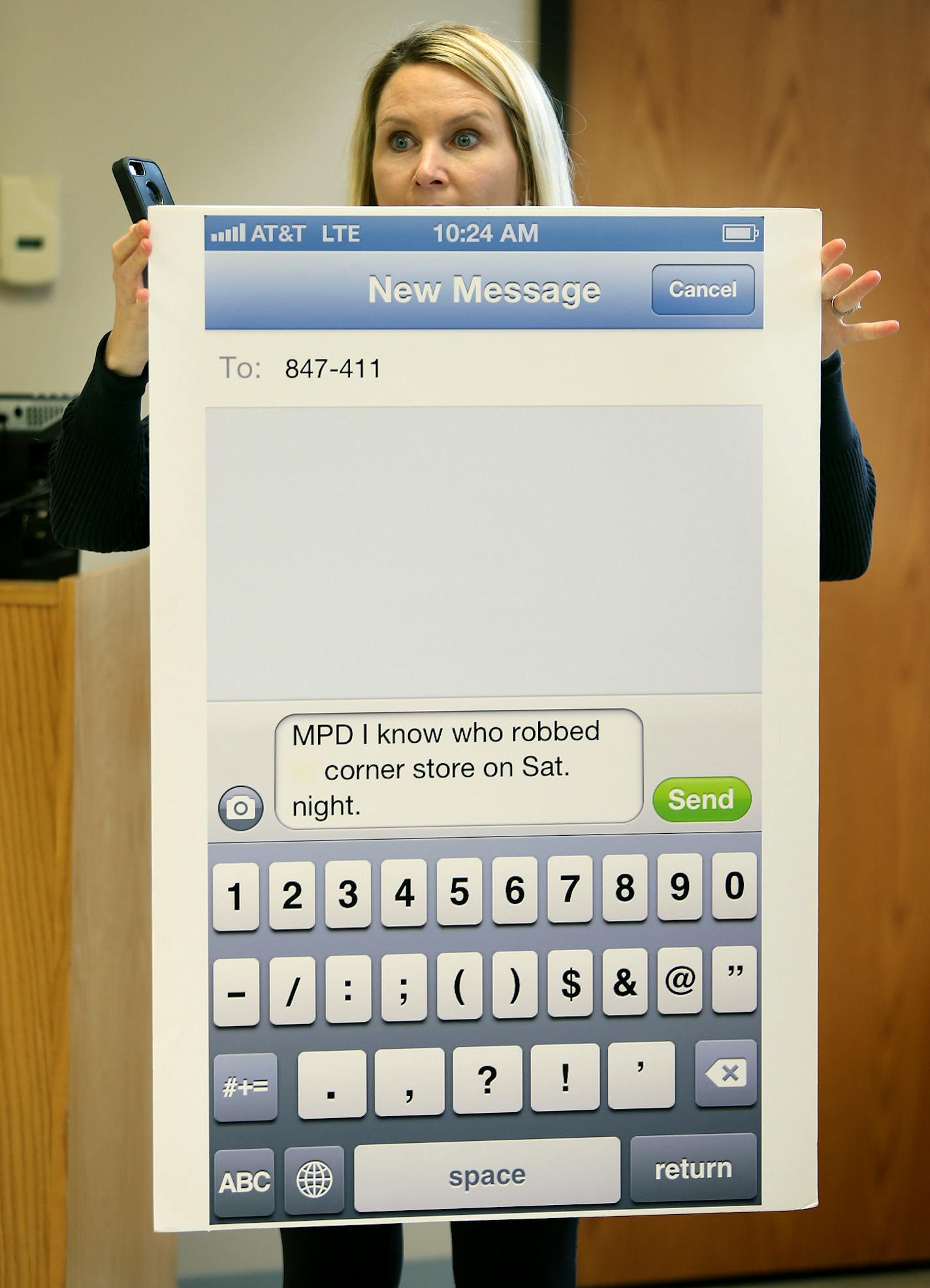 Minneapolis Police Public Information Officer Cyndi Barrington held up a new app that will allow people to text in tip information regarding crimes during a press conference regarding the sexual assault of a girl near the University of Minnesota, Monday.