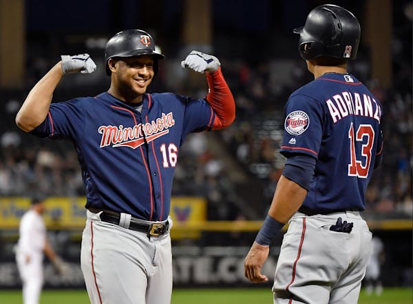 Ehire Adrianza and Jonathan Schoop of the Twins celebrate after the three-run home run in the second inning against the Chicago White Sox at Guarantee
