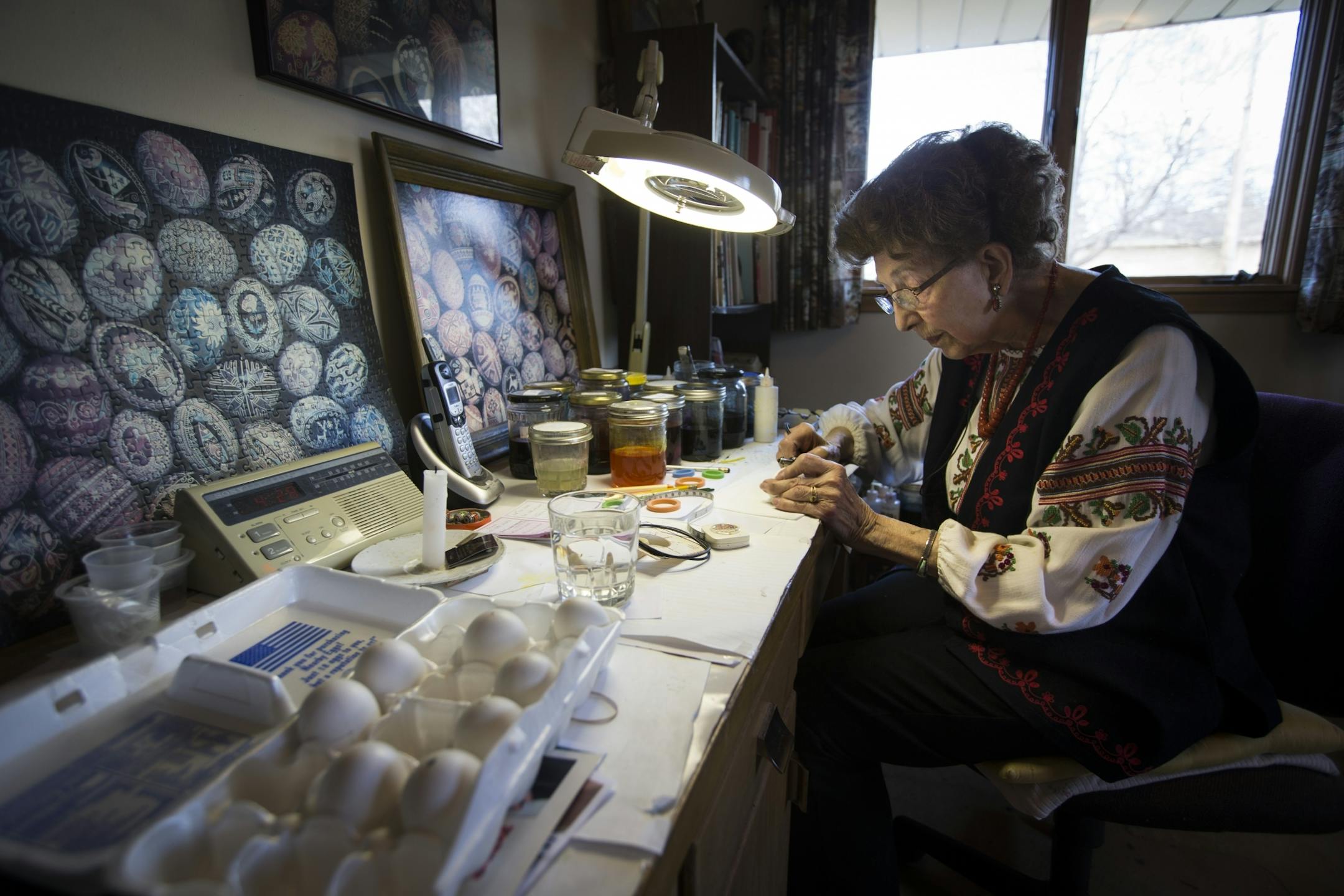 Luba Perchyshyn, 91, is known worldwide for the Ukrainian easter eggs she has handmade for the last 87 years. She worked on an egg at her desk at home where she does all her work in St. Anthony, Minn., on Thursday, March 26, 2015.