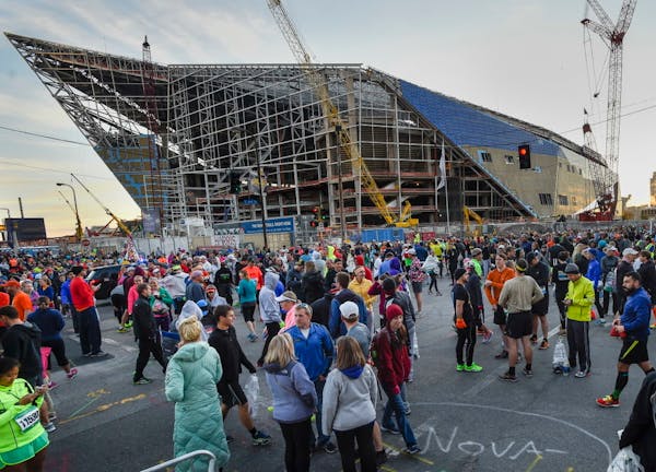 Runners and others gathered near the U.S. Bank Stadium construction site before the start of the Twin Cities Marathon in Minneapolis in October.