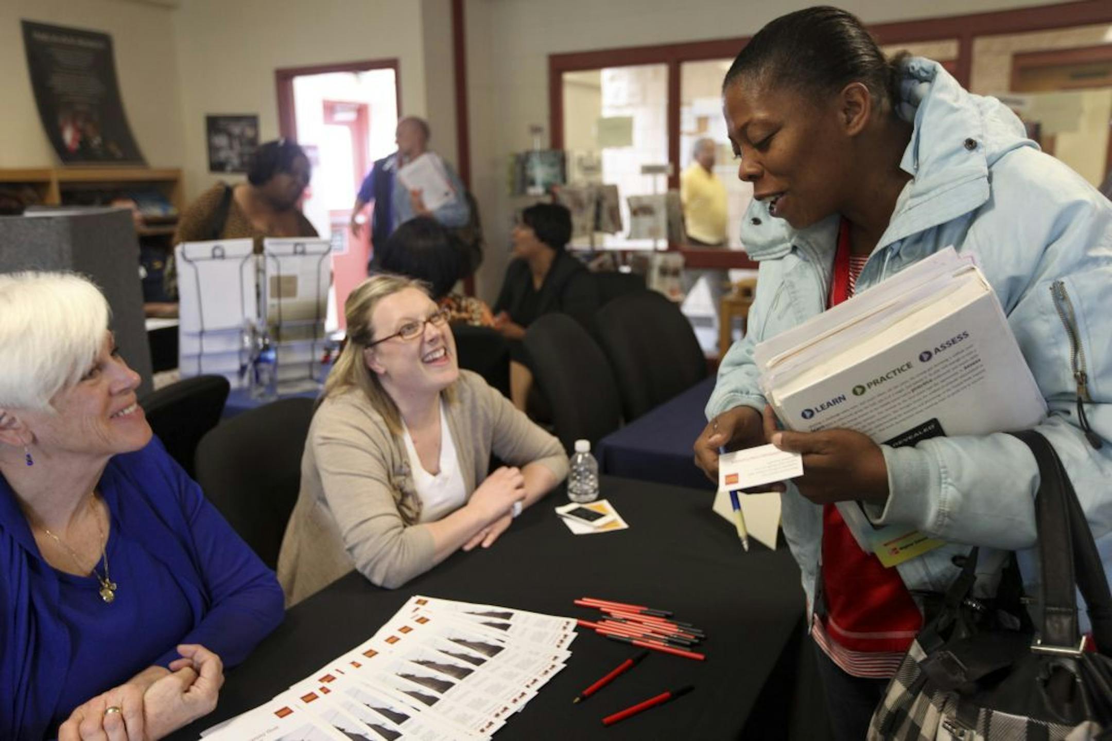Wells Fargo recruiters Leah Murphy, right, and Eileen Forrester spoke with Ihisha Anderson, of Minneapolis, at a career fair Wednesday.