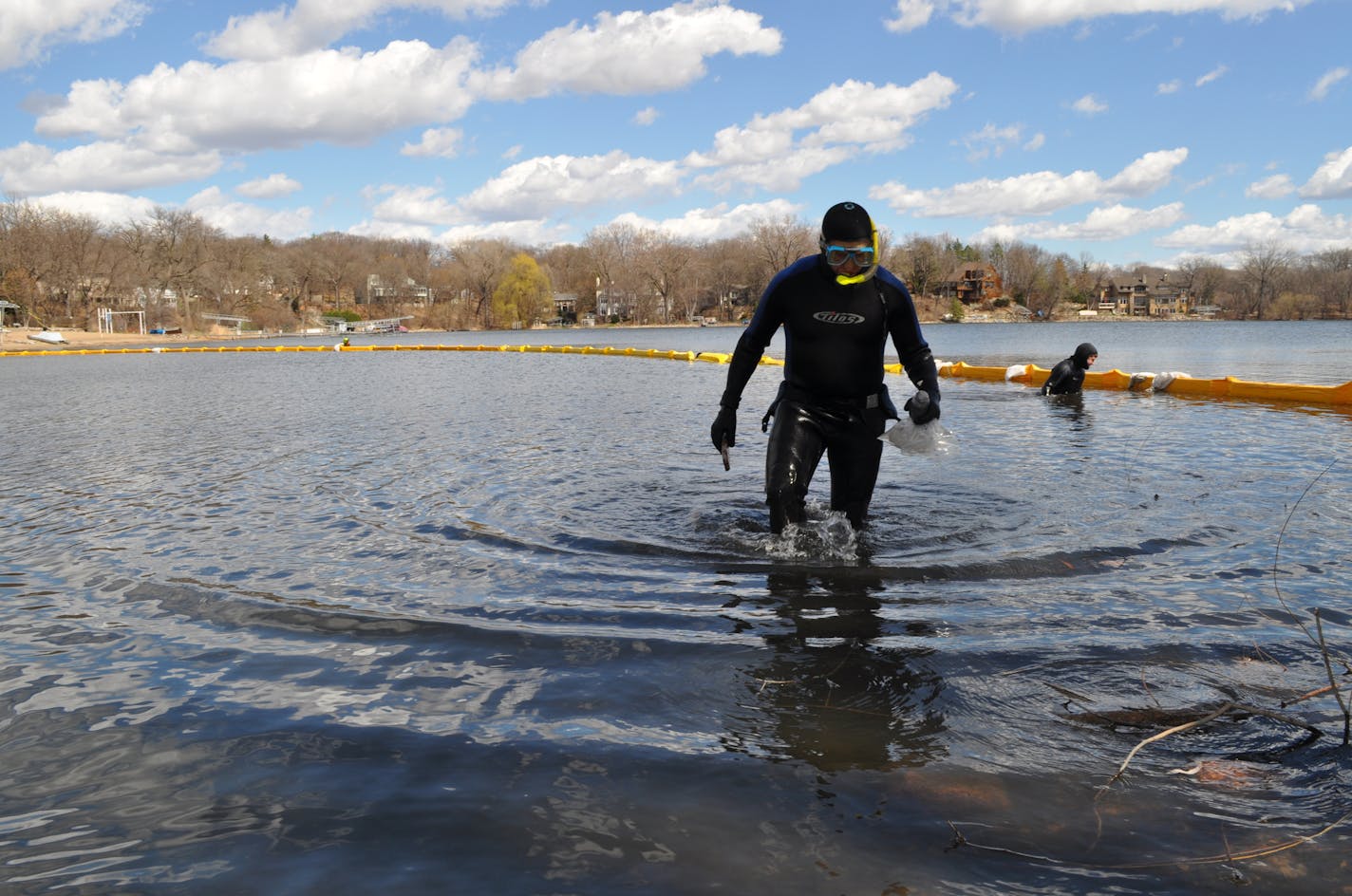 Divers from Blue Water Science and Waterfront Restorations search the area around the Christmas Lake boat launch on April 13. They found no evidence of zebra mussels inside and directly outside the area that was treated with three different treatments last fall and winter. Photo submitted by Minnehaha Creek Watershed District.