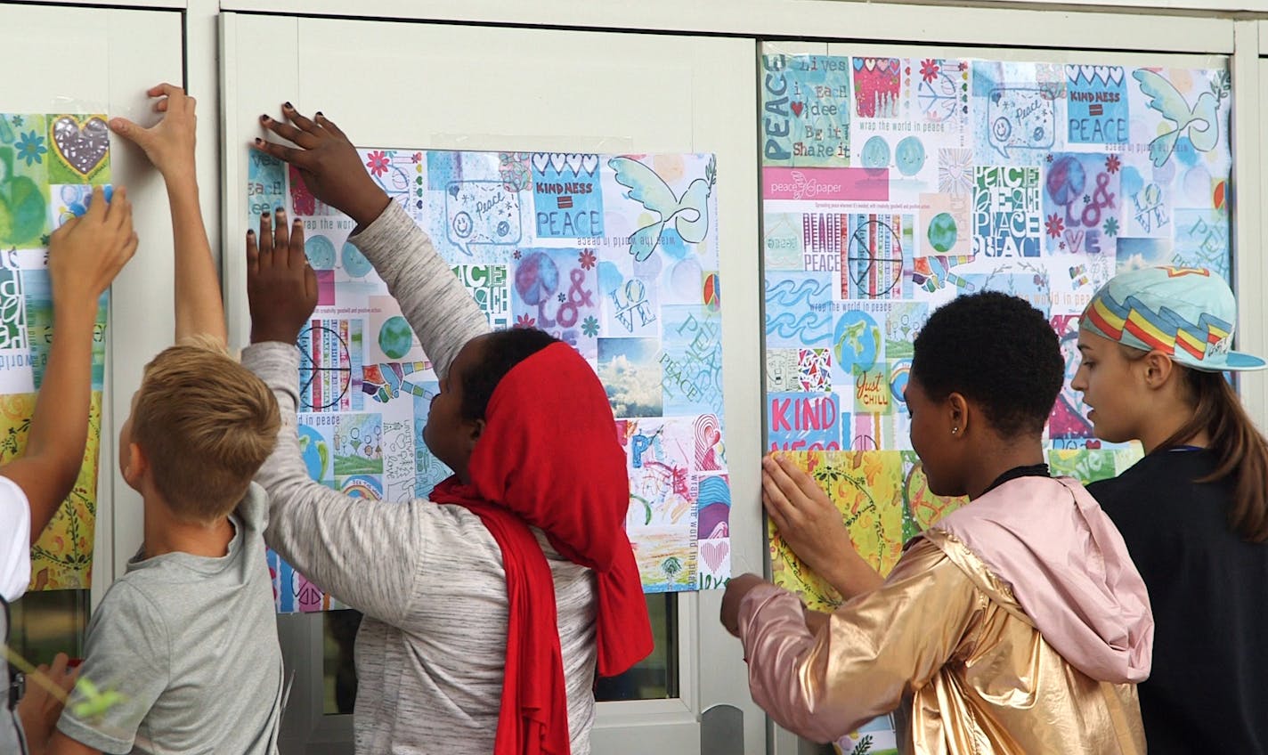 Three Hopkins West Junior High students died last school year, sending a massive wave of grief and sorrow among the student body. On Friday morning, the International Day of Peace, the students decorated the school with wallpaper containing messages of peace and unity. ] Matt Gillmer / Star Tribune 092118