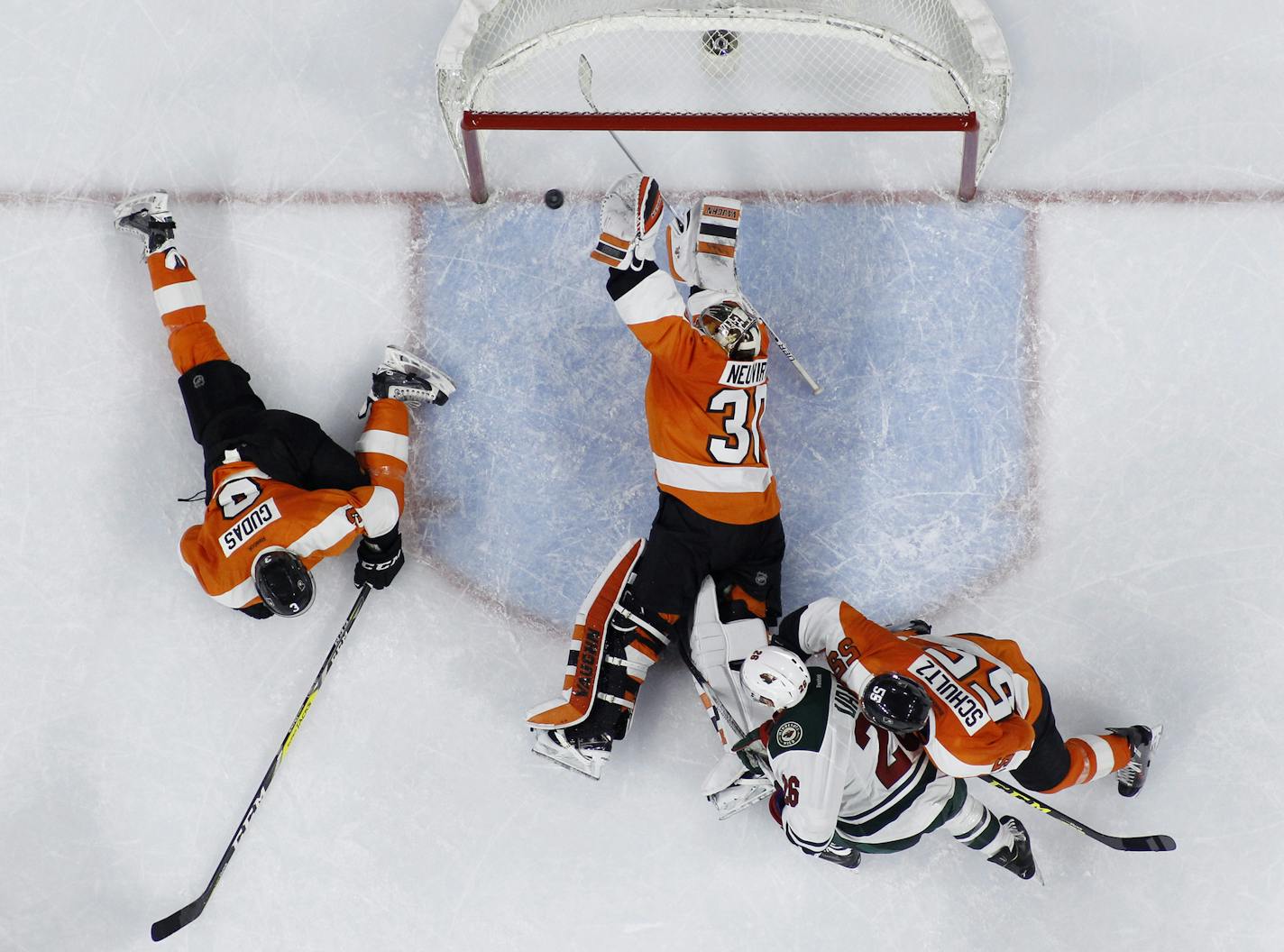 Philadelphia Flyers' Michal Neuvirth (30) blocks a shot by Minnesota Wild's Charlie Coyle past Radko Gudas (3), Nick Schultz (55) and Thomas Vanek (26) during the final seconds of an NHL hockey game, Thursday, Feb. 25, 2016, in Philadelphia. Philadelphia won 3-2. (AP Photo/Matt Slocum)