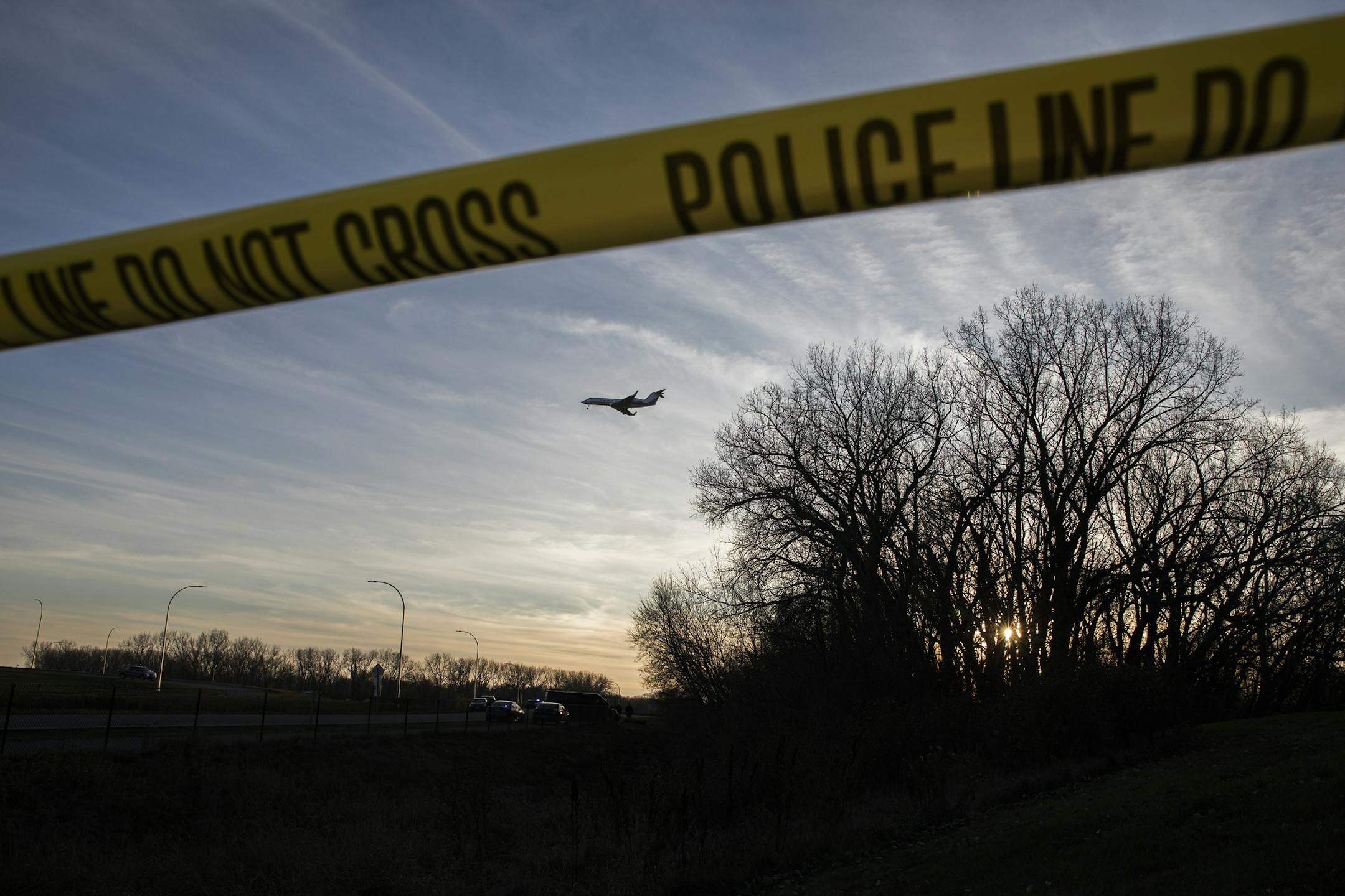 A plane takes off near the scene where a body was found in a wooded area in Solomon Park near Cedar Avenue and 58th Street in Minneapolis. ] LEILA NAVIDI &#xef; leila.navidi@startribune.com BACKGROUND INFORMATION: Police presence is seen in Solomon Park near Cedar Avenue and 58th Street where a body was found in a wooded area in Minneapolis on Sunday, November 19, 2017. ORG XMIT: MIN1711191707530342