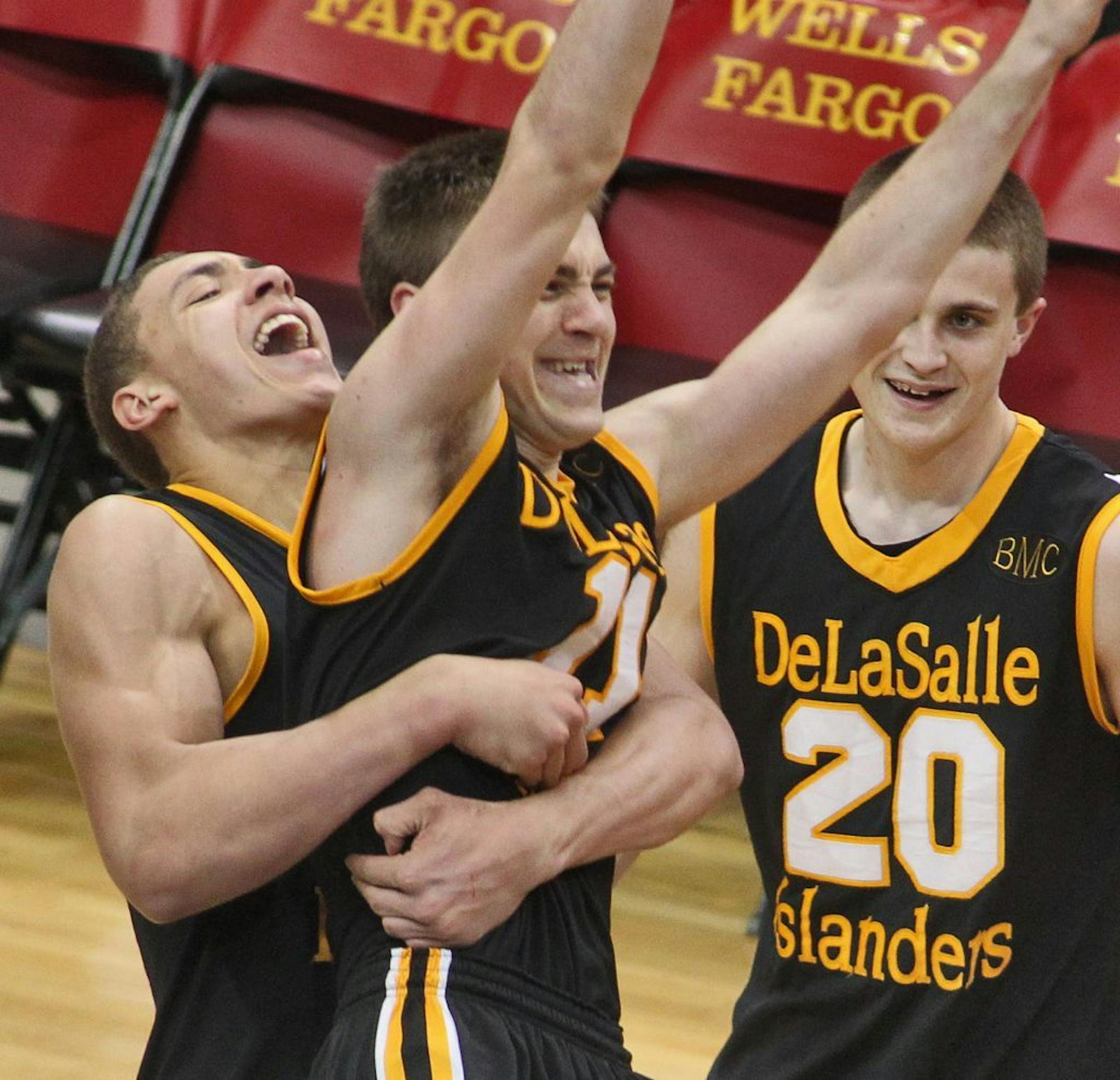Class 3A Boys Prep Basketball Championship - DeLaSalle vs. Minneapolis Washburn. DeLaSalle won in overtime 57-56. Teammates, including Reid Travis, left, hugged Ross Barker at the end of the game after he scored the winning basket in overtime. (MARLIN LEVISON/STARTRIBUNE(mlevison@startribune.com