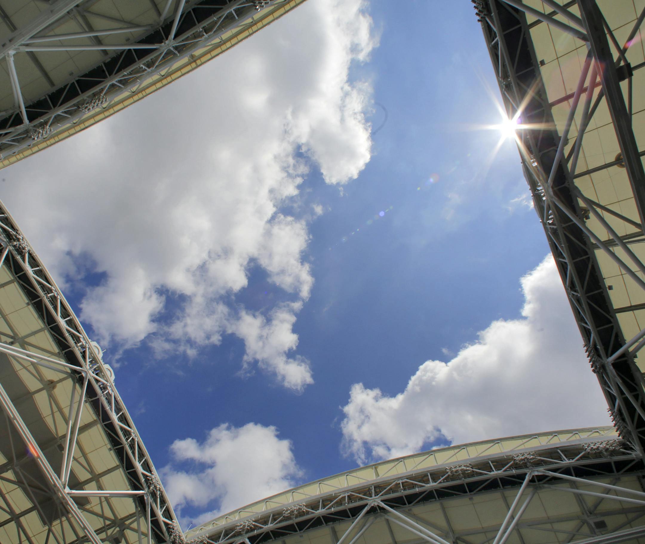 The sun peaks into Arthur Ashe Stadium through the new retractable roof, at the Billie Jean King National Tennis Center, in the Queens borough of New York, Tuesday, Aug. 2, 2016. Mother Nature will no longer be a problem at the U.S. Open as the U.S. Tennis Association unveiled the new retractable roof over Arthur Ashe Stadium. (AP Photo/Richard Drew) ORG XMIT: MIN2016082817243744