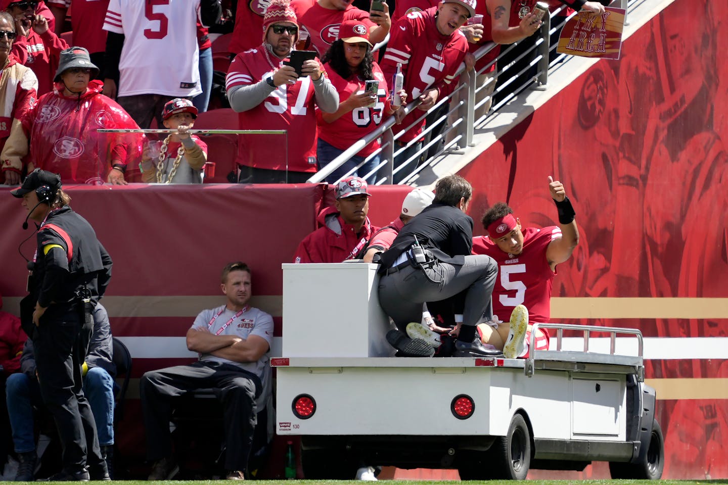 San Francisco 49ers quarterback Trey Lance gestures while being carted off the field Sunday. He is out for the season.