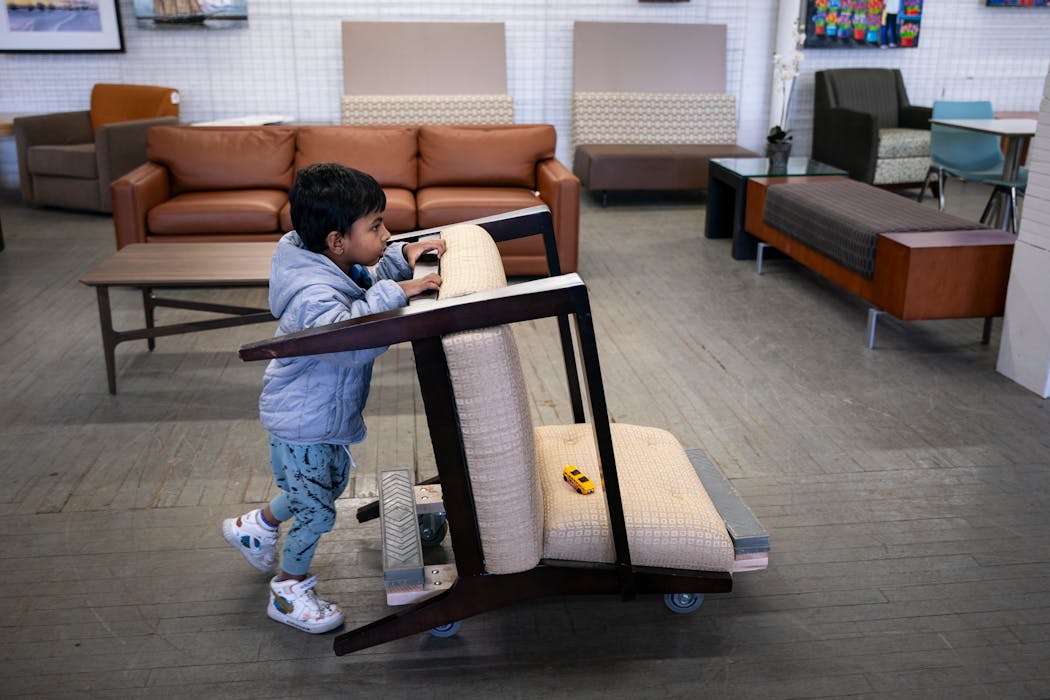 Pranay Divakar pushes his family's new chair from Furnish Office and Home.