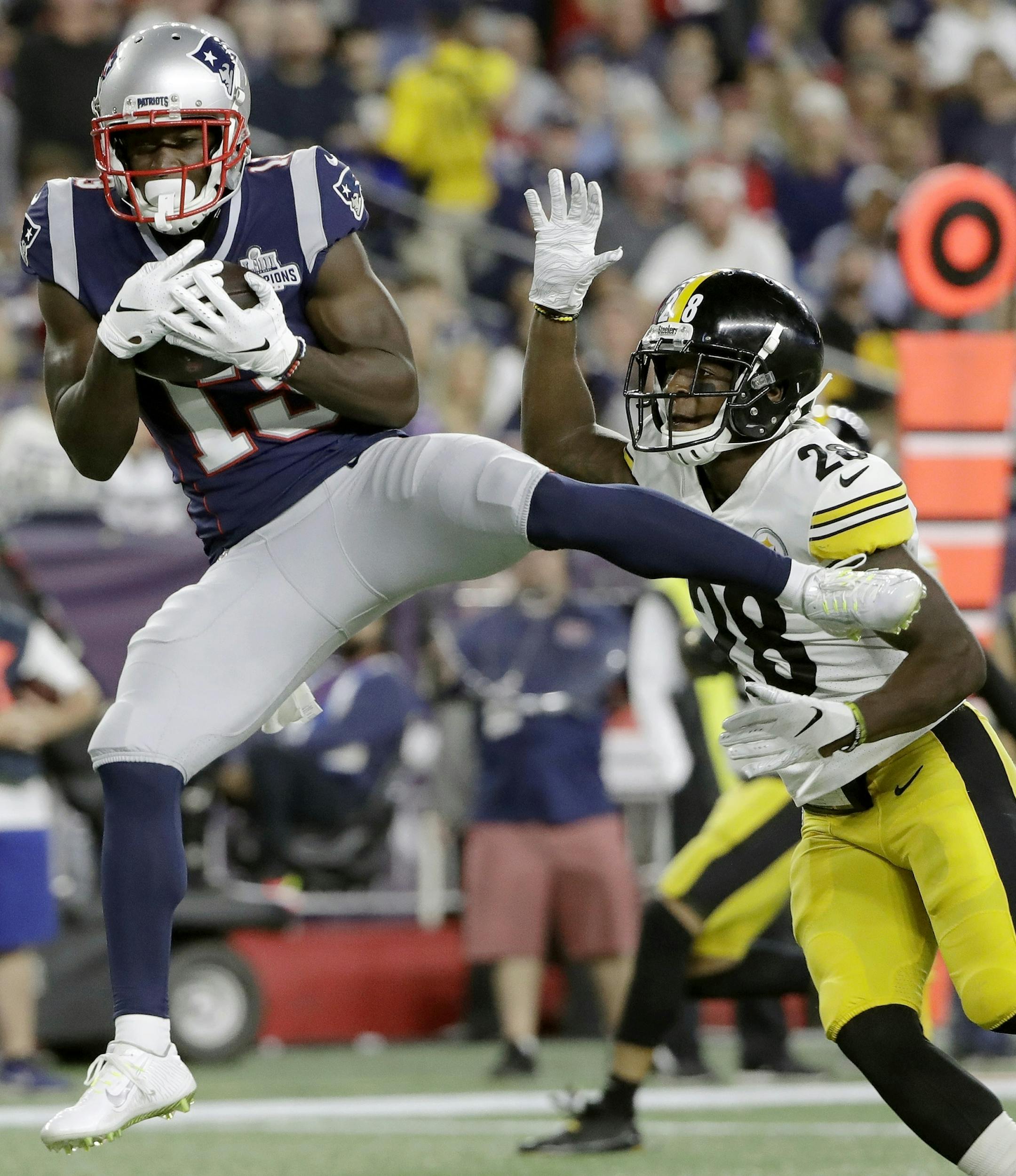 New England Patriots wide receiver Phillip Dorsett, left, catches a touchdown pass in front of Pittsburgh Steelers cornerback Mike Hilton in the first half an NFL football game, Sunday, Sept. 8, 2019, in Foxborough, Mass. (AP Photo/Steven Senne)