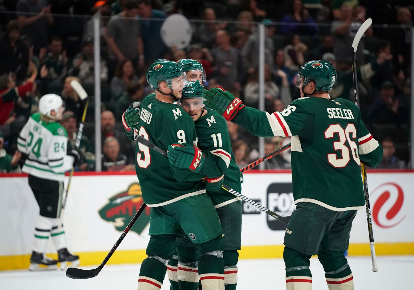 Wild left wing Zach Parise (11) was congratulated by teammates, including center Mikko Koivu (9) and defenseman Nick Seeler (36) after he scored in the second period