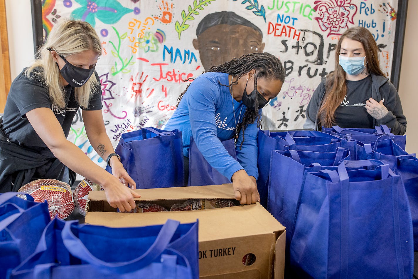 The Link's CEO Beth Holger, left, Kesha Bradford, the housing and support services director, center and Angel Otis, unload Thanksgiving donations from the Vikings to their headquarters in Minneapolis, Minn., on Tuesday, November 23, 2021. The non-profit founded three decades ago by two former Minnesota Vikings, recently received the biggest single donation in the group's history: $2.5 million from the Bezos Day 1 Families Fund. It will go to fight family homelessness in the Twin Cities. ] Elizabeth Flores • liz.flores@startribune.com