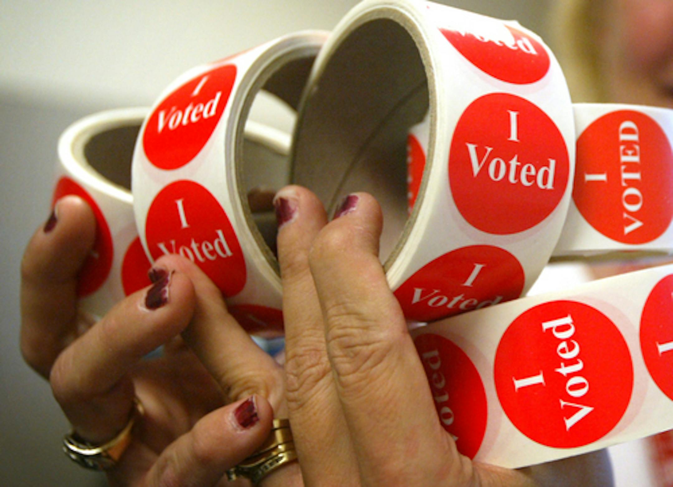 Lori Brown holds a handful of "I voted" stickers that she will organize into supply bins to be delivered to each polling place for the primary elections next week. Brown is a temporary employee who helps out with the elections at the Scott County Government Center. There are 44 precincts Scott County. Stribsouth RenÃˆe Jones/Star Tribune 9/8/04 ORG XMIT: MIN2013100910022654 ORG XMIT: MIN1311051521527862