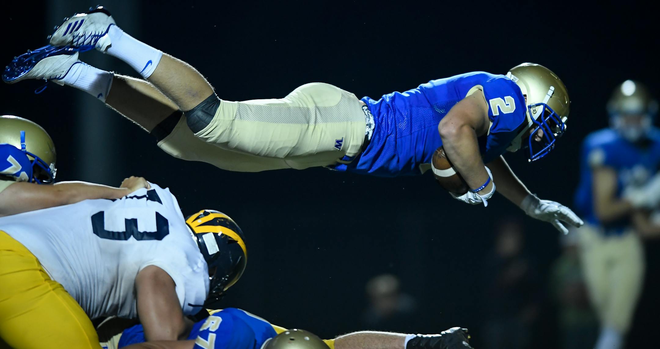 Wayzata tight end Billy Riviere (2) dove over Rosemount defenders for a second half touchdown Thursday night. ] AARON LAVINSKY ï aaron.lavinsky@startribune.com Wayzata played Rosemount in a high school football game on Thursday, August 31, 2017 at Wayzata High School in Plymouth, Minn.