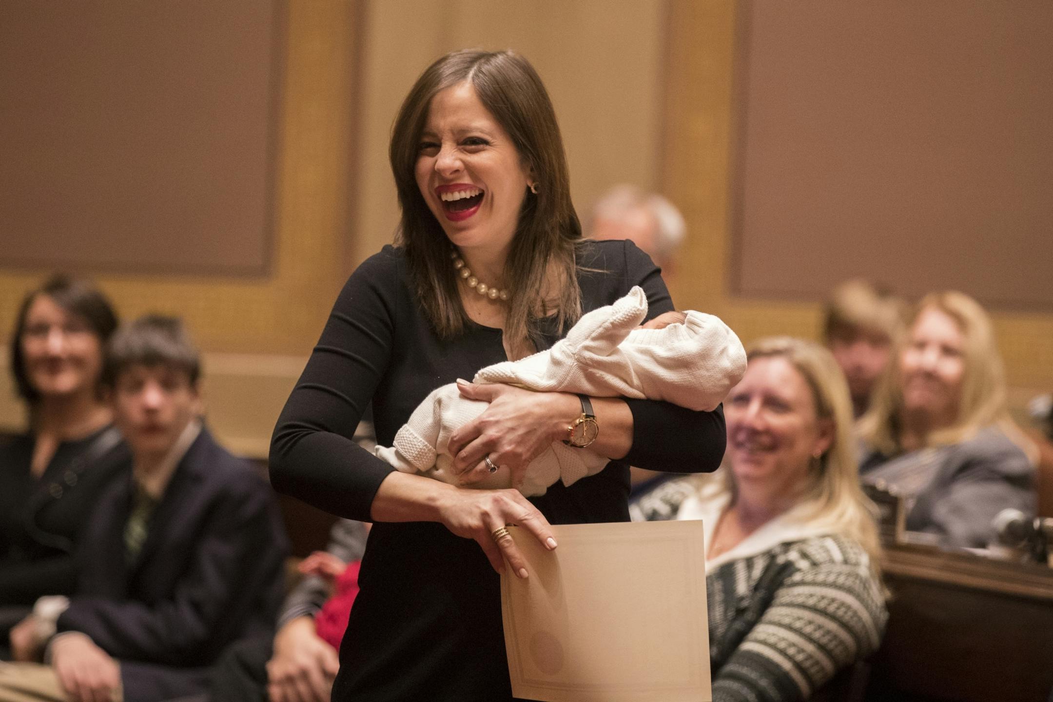 Sen. Melissa Franzen, DFL-Edina, holds her six-day-old son during the first session of Minnesota Senate chambers.