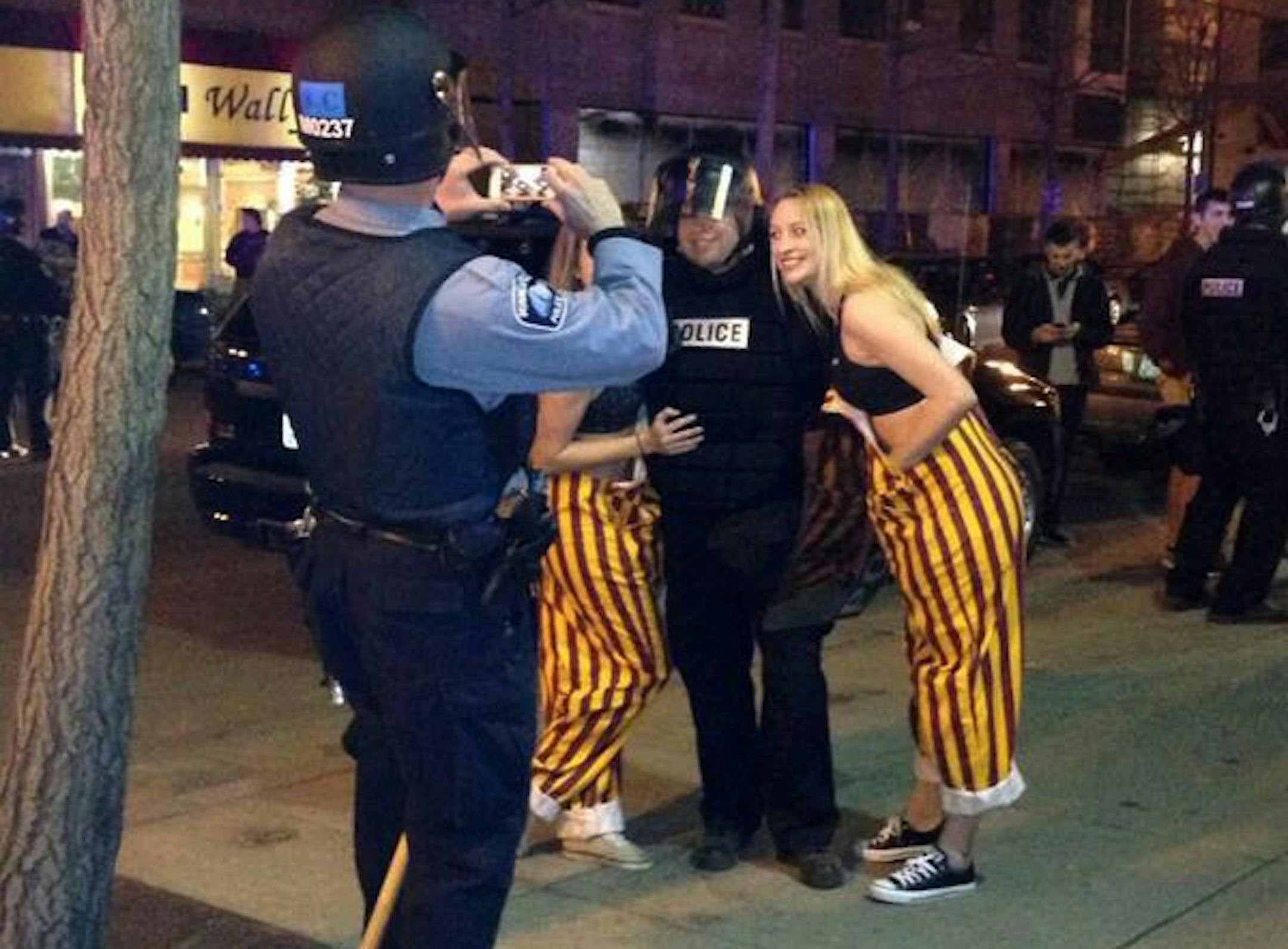 University of Minnesota student Becca Leighton took this photo of students and police in Dinkytown after the post-game disturbance had been quelled after the Gophers Frozen Four win on Thursday night, April 10, 2014.